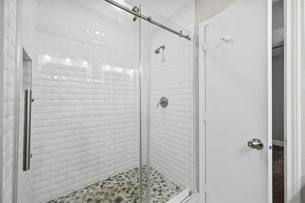 a bathroom with a shower and a sink
