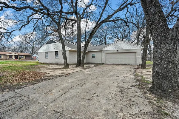 a house that has a tree in front of it
