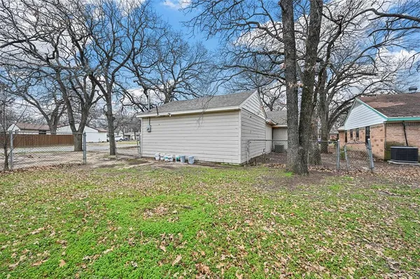 a view of a backyard with large trees