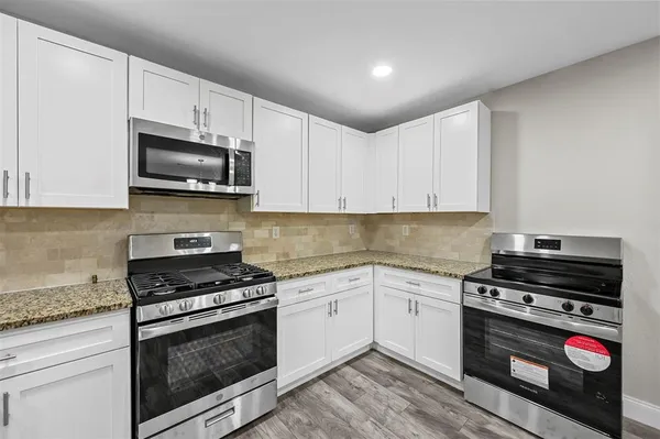 a kitchen with cabinets and appliances