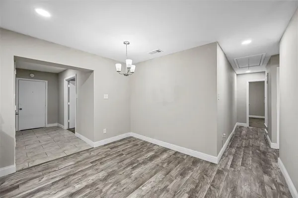 wooden floor in an empty room with a mirror