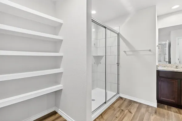 a bathroom with a shower and a sink