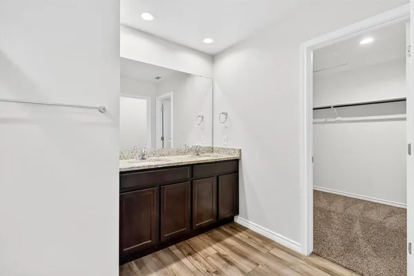 a bathroom with a double vanity sink and mirror