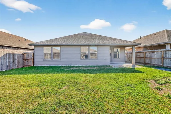 a view of a house with a backyard