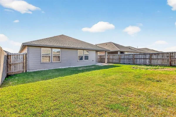 a view of a house with a backyard