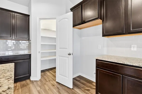 a view of a refrigerator and wooden floor