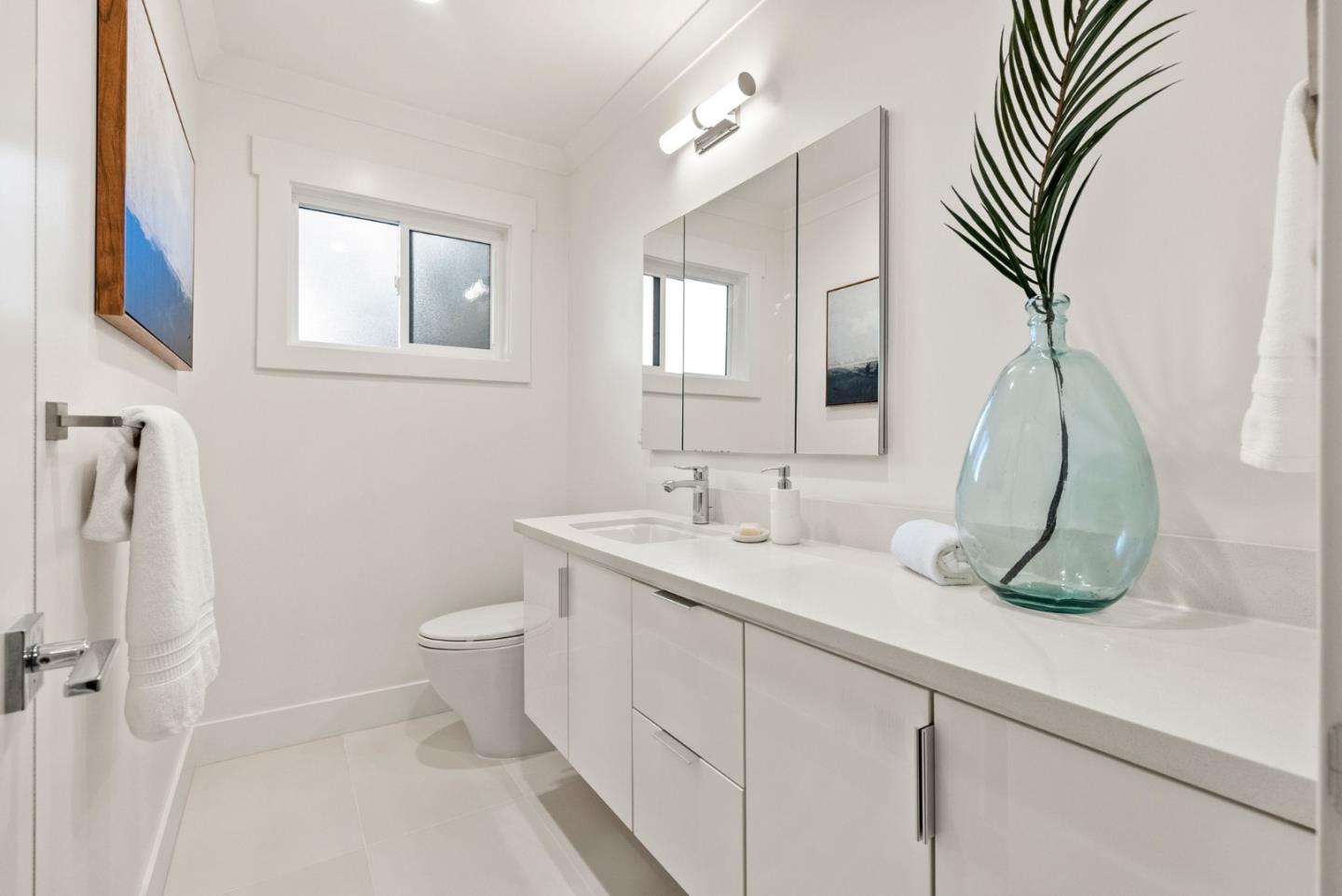 625 Kingsley Avenue Palo Alto, CA 94301 - Photo 14 of 24 a bathroom with a sink a toilet and mirror