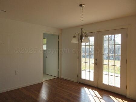 4416 South Hayden Street Amarillo, TX 79110 - Photo 5 of 15 a view of an empty room with wooden floor and a window