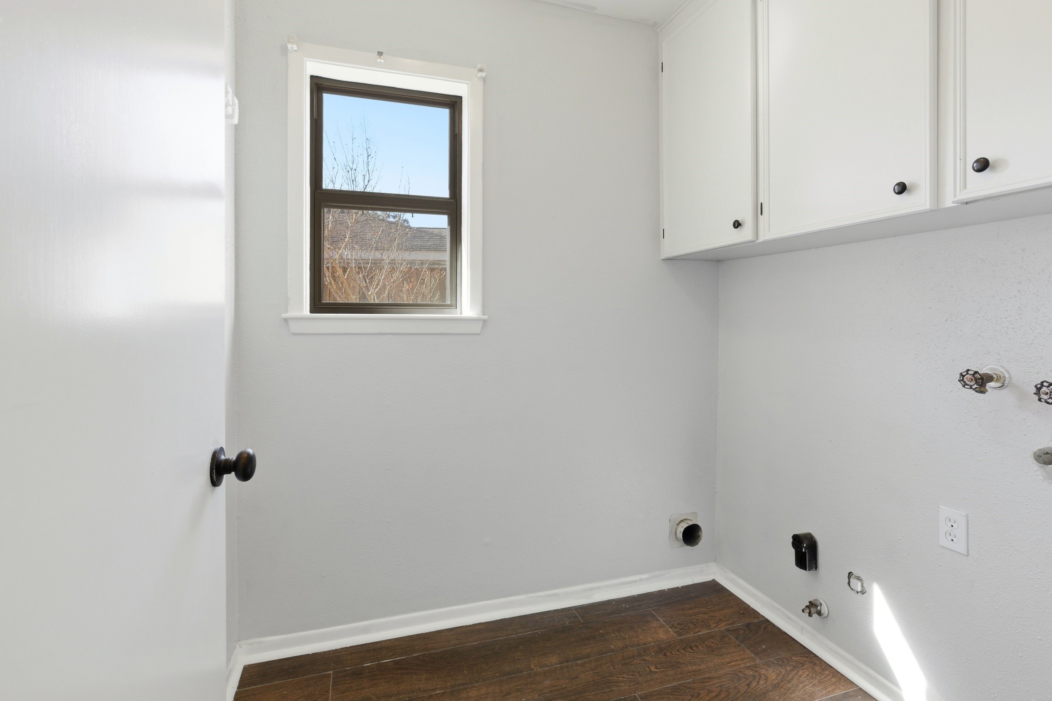 3721 Avenue R Rosenberg, TX 77471 - Photo 20 of 43 Laundry room conveniently located off the kitchen with upper cabinetry for storage and nearby access to the garage.