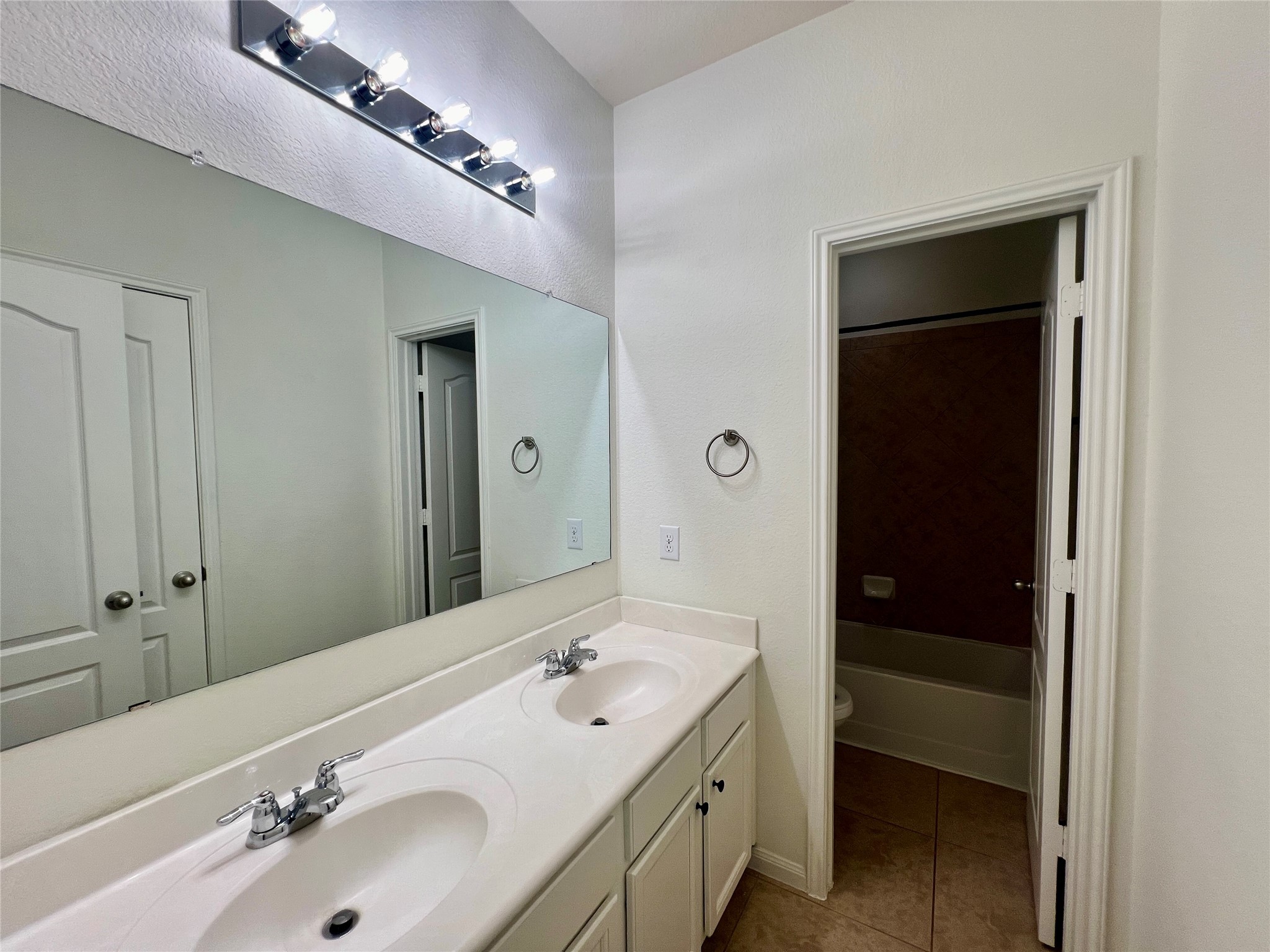 25307 Holton Ridge Drive Katy, TX 77494 - Photo 23 of 26 a bathroom with a double vanity sink and mirror