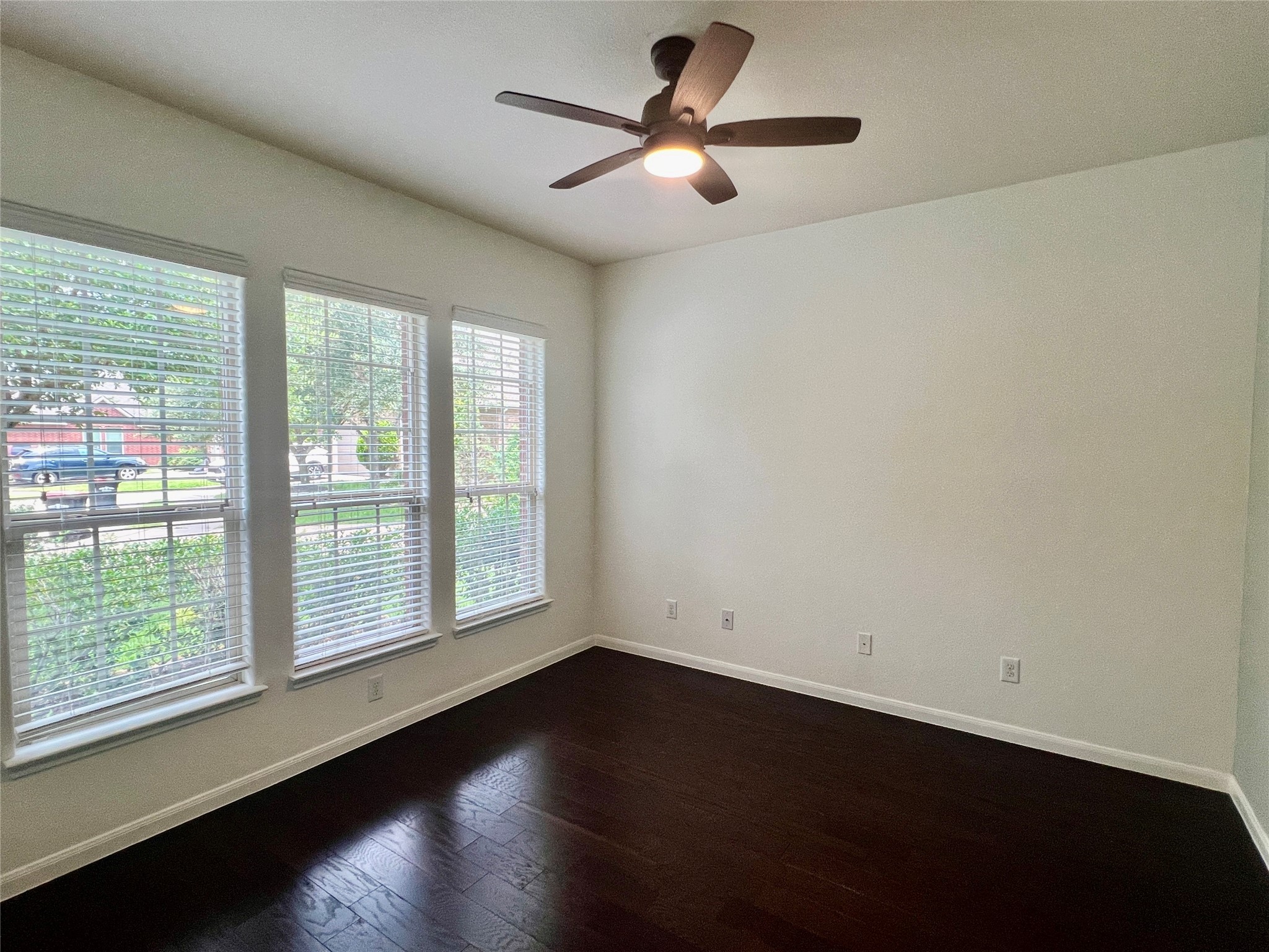 25307 Holton Ridge Drive Katy, TX 77494 - Photo 5 of 26 an empty room with wooden floor and windows