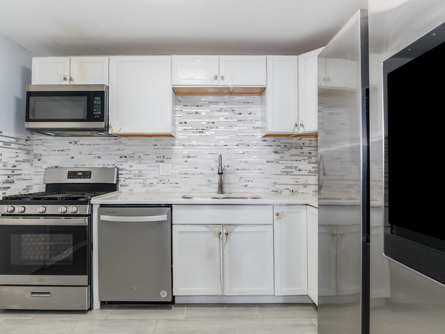 4721 St Joseph Creek Road, Unit 5F Lisle, IL 60532 - Photo 11 of 19 a kitchen with stainless steel appliances granite countertop a stove microwave and sink