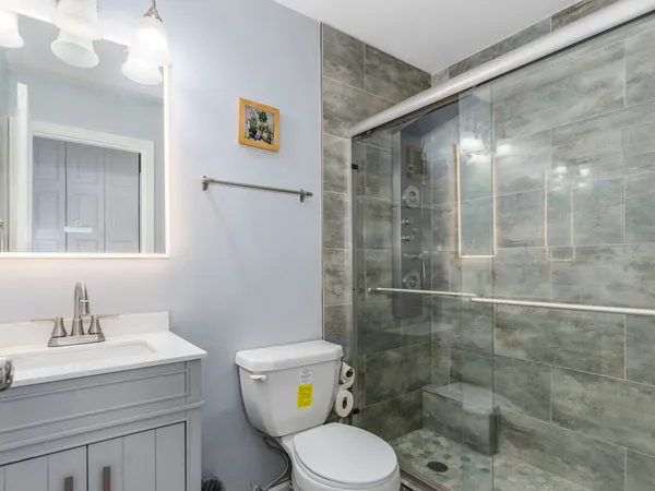a bathroom with a sink toilet and shower
