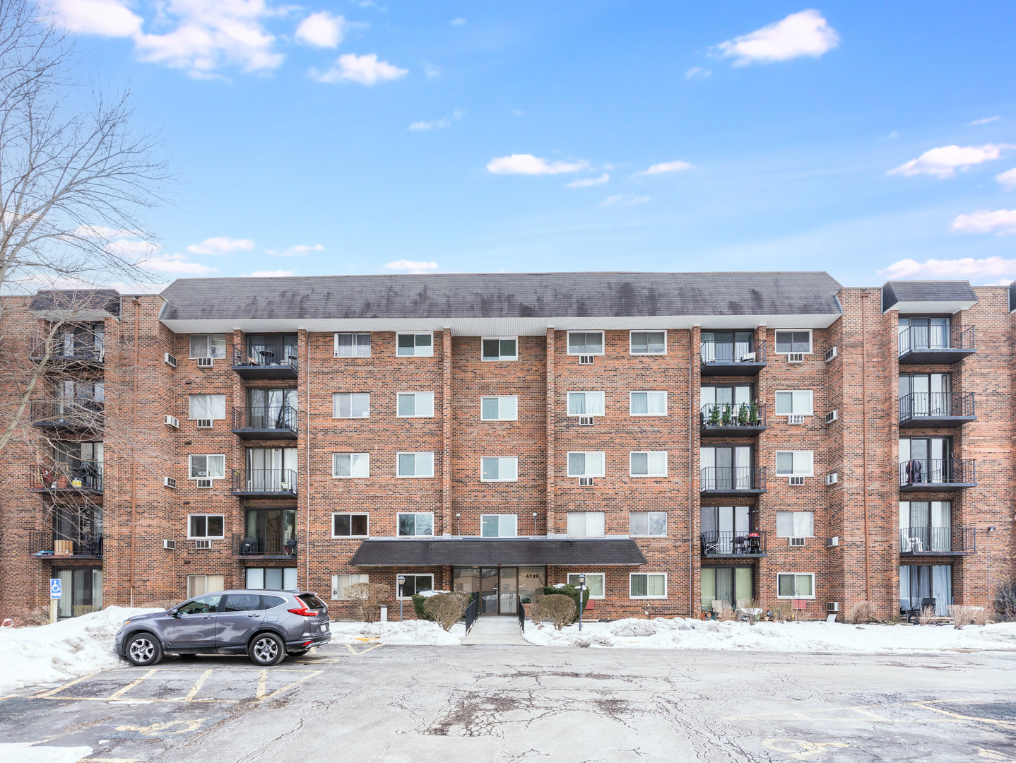 4721 St Joseph Creek Road, Unit 5F Lisle, IL 60532 - Photo 2 of 19 a front view of a building with a street