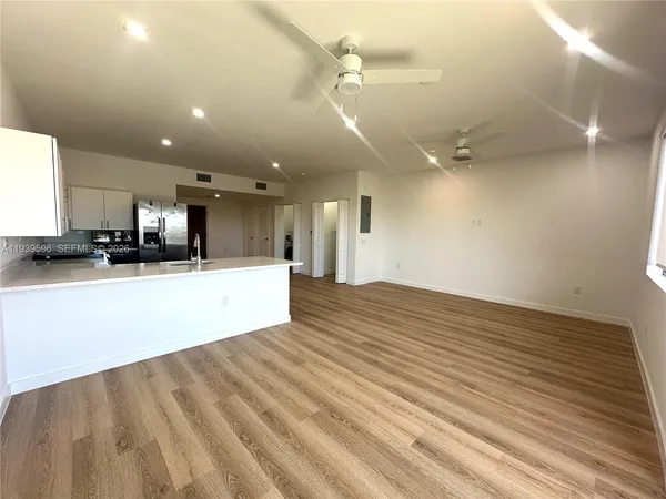 a view of kitchen with kitchen island microwave and stove