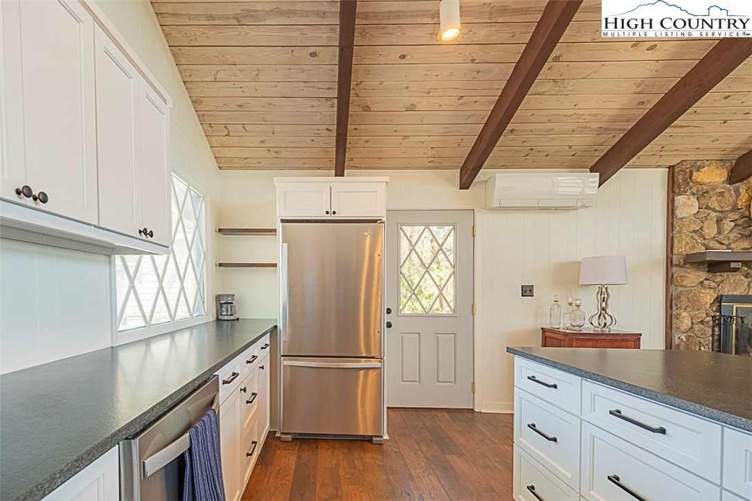89 Rabbit Run Glade Valley, NC 28627 - Photo 14 of 32 a kitchen with a refrigerator a sink and dishwasher with wooden floor