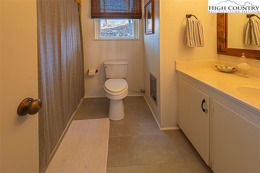 89 Rabbit Run Glade Valley, NC 28627 - Photo 20 of 32 a bathroom with a toilet sink and mirror