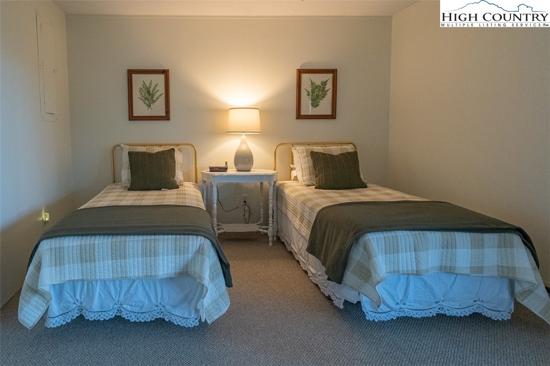 89 Rabbit Run Glade Valley, NC 28627 - Photo 21 of 32 a bedroom with a bed and painting on the wall