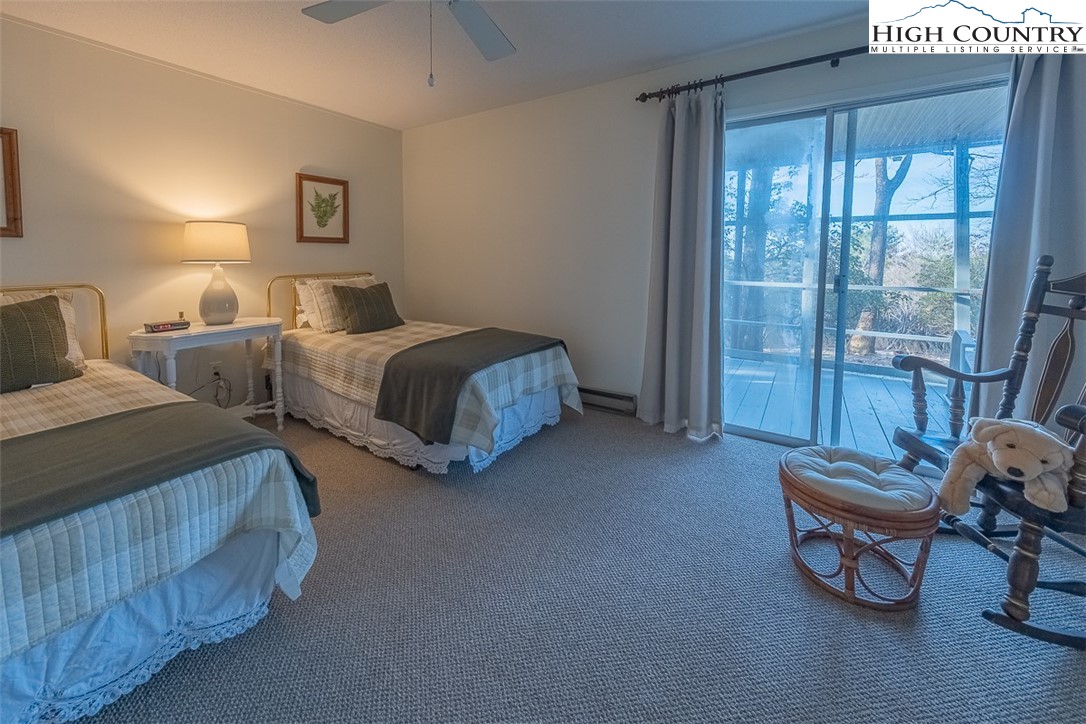 89 Rabbit Run Glade Valley, NC 28627 - Photo 22 of 32 a spacious bedroom with two beds and glass door