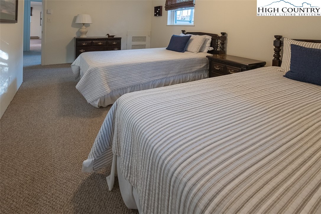 89 Rabbit Run Glade Valley, NC 28627 - Photo 24 of 32 a bedroom with two beds and a night stand