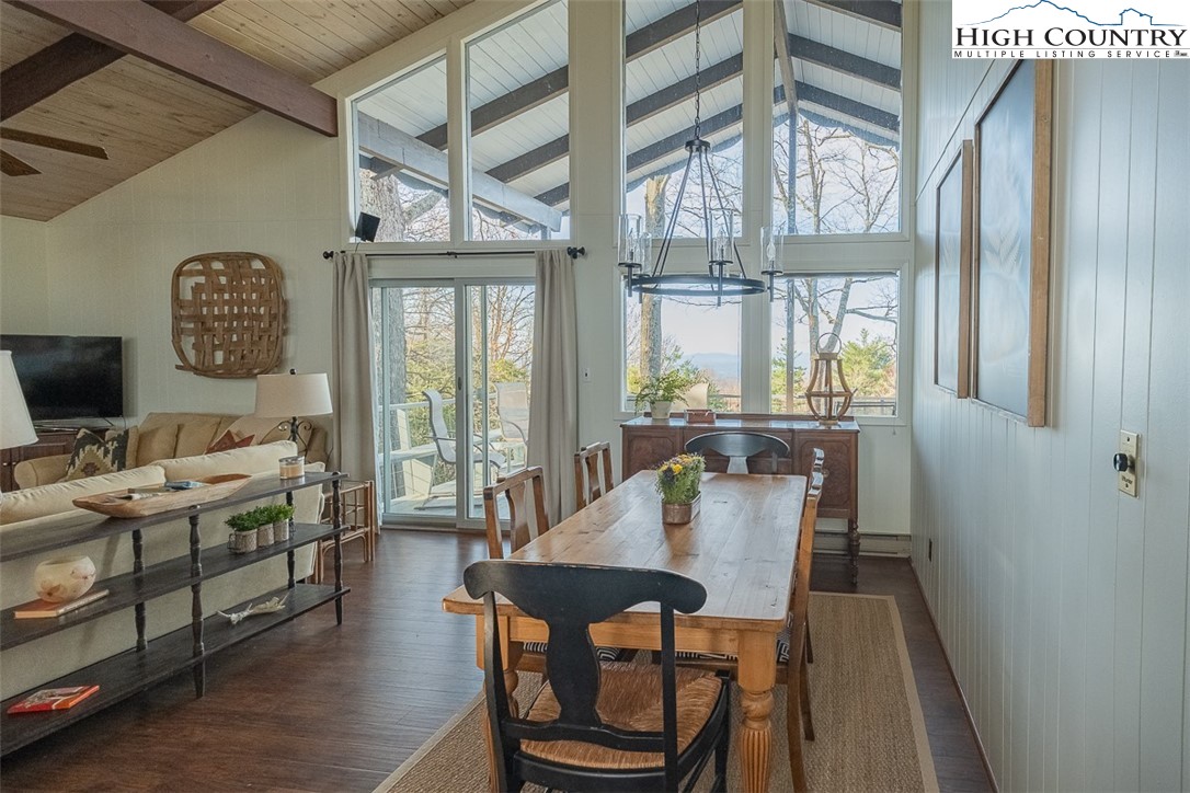 89 Rabbit Run Glade Valley, NC 28627 - Photo 6 of 32 a view of a dining room with furniture a chandelier and wooden floor
