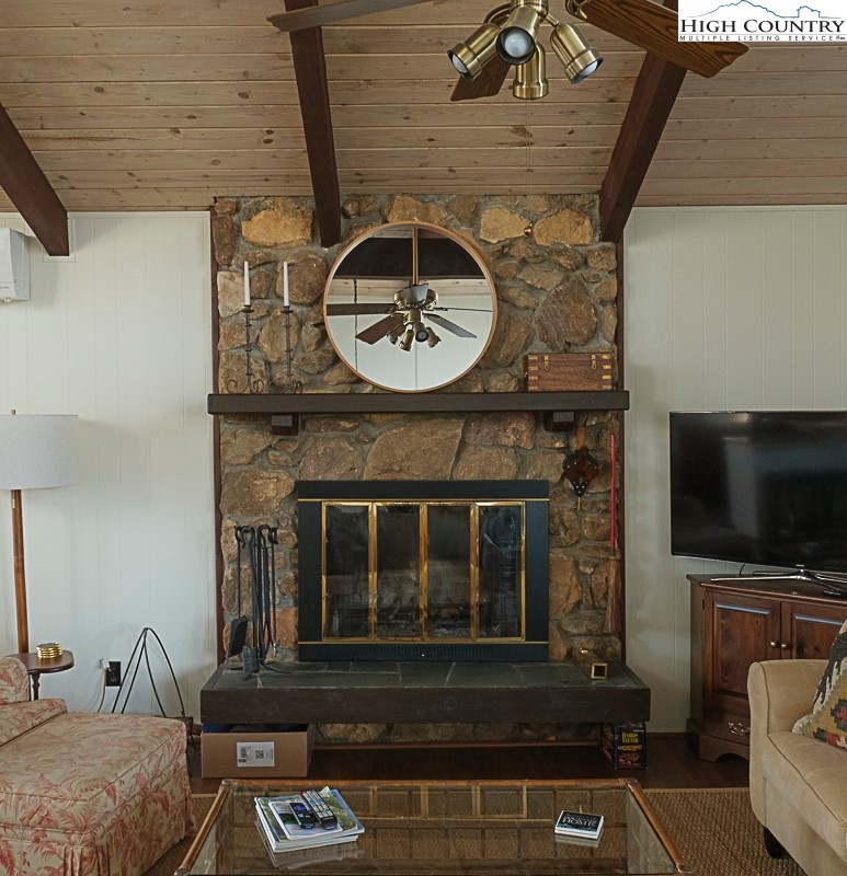 89 Rabbit Run Glade Valley, NC 28627 - Photo 8 of 32 a living room with a fireplace and a flat screen tv