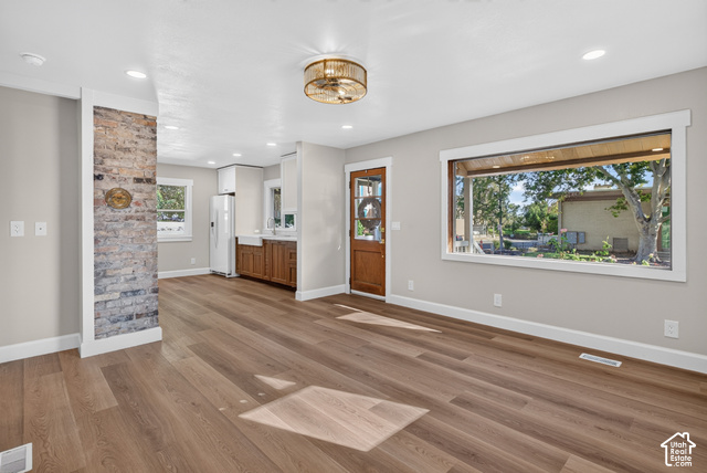 147 Center Street Clearfield, UT 84015 - Photo 27 of 55 Wood-finish flooring, exposed brick accent wall, recessed lighting, large picture window, and a decorative ceiling fixture