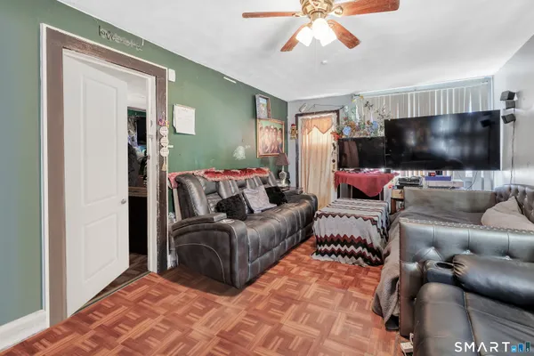 a living room with furniture and a flat screen tv
