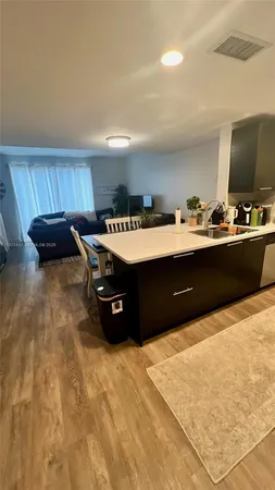 a room with a flat screen tv and appliances