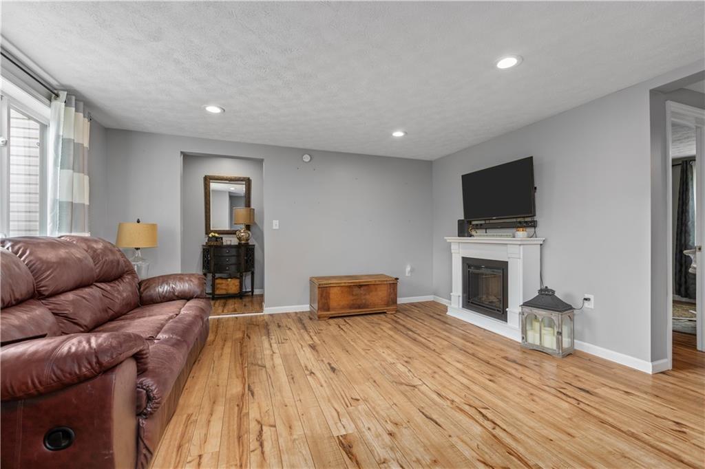231 Hannahstown Road Cabot, PA 16023 - Photo 4 of 25 a living room with furniture and a flat screen tv