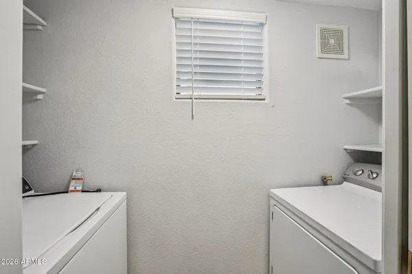 a bedroom with a bed and a lamp