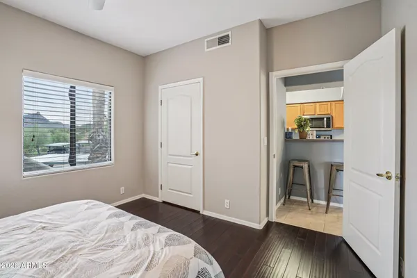 a bedroom with a large bed and a chandelier