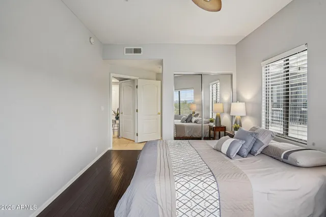 a bedroom with a large bed and a chandelier