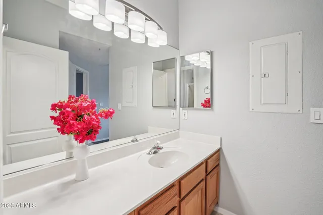 a bathroom with a sink vanity mirror and toilet
