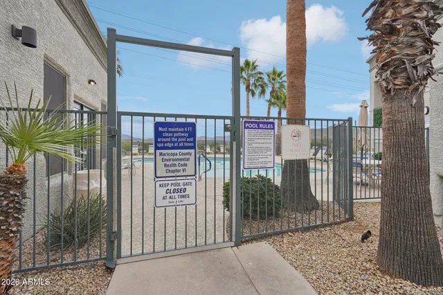 a view of a swimming pool with a table and chairs