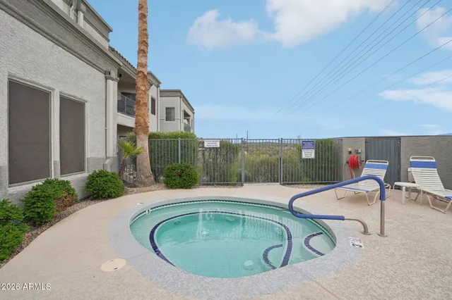 a balcony with table and chairs