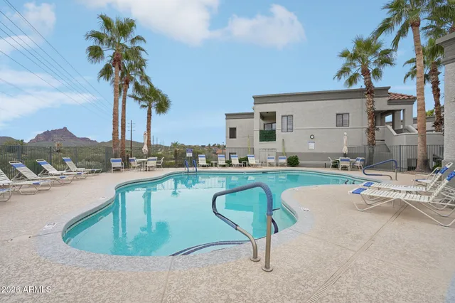 a view of a swimming pool with outdoor seating