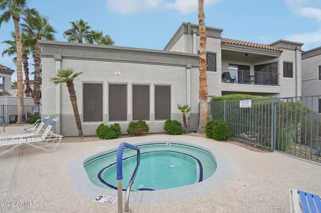 a view of a house with swimming pool and a porch with furniture