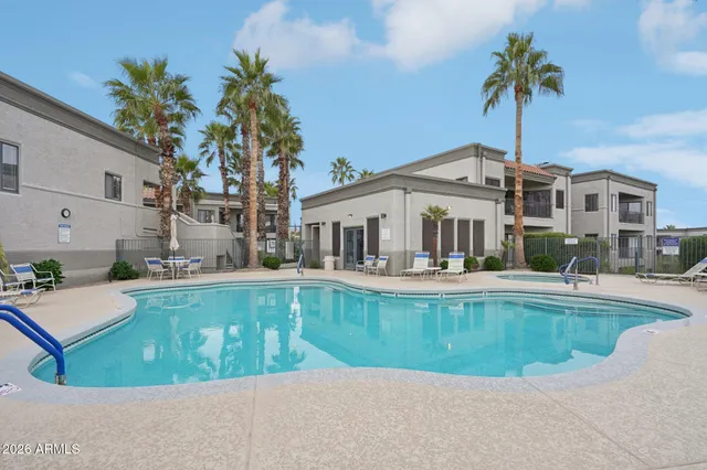 a view of a outdoor sitting area with furniture and umbrella