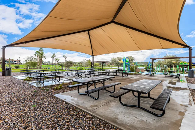a view of a swimming pool with a table and chairs under an umbrella