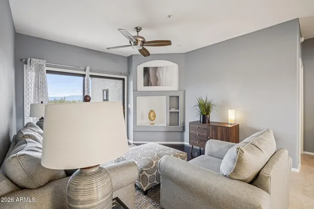 a living room with furniture and a large window
