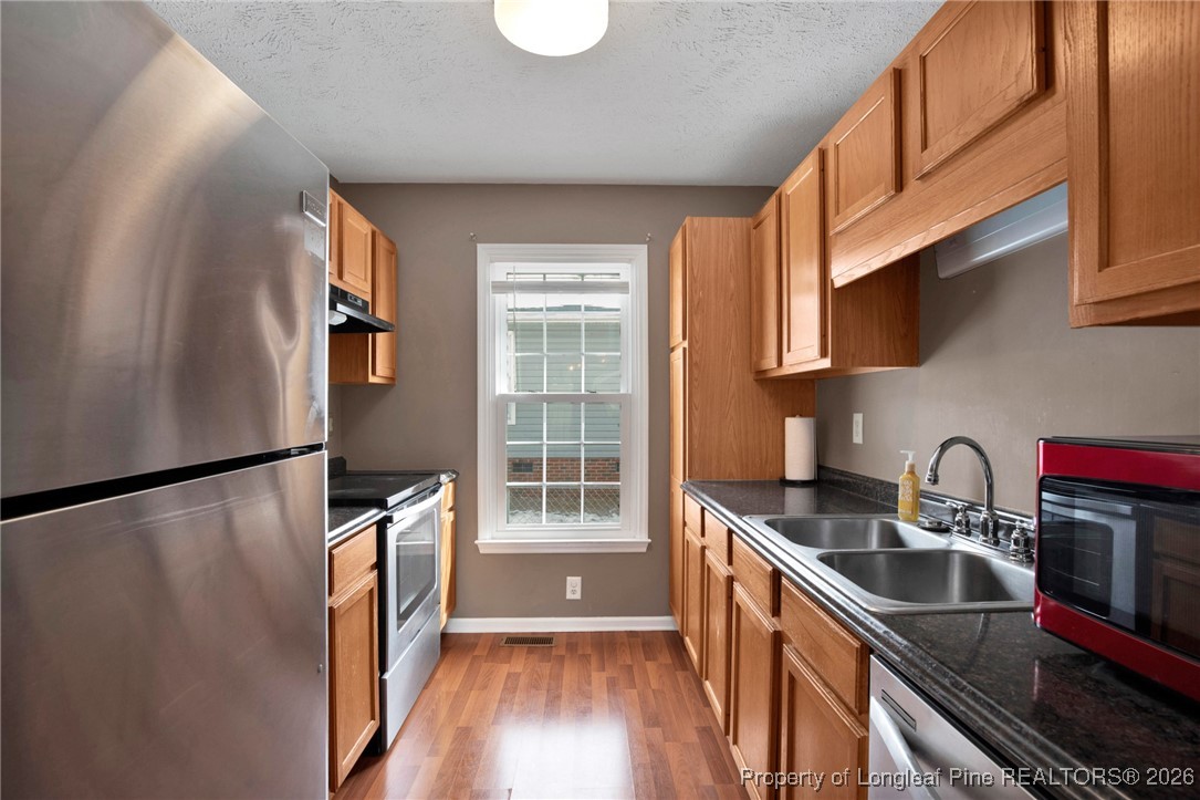 3824 Constance Road Hope Mills, NC 28348 - Photo 12 of 32 a kitchen that has a sink a refrigerator and window