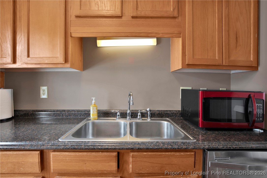 3824 Constance Road Hope Mills, NC 28348 - Photo 14 of 32 a kitchen with granite countertop a sink and a stove