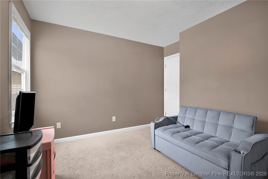 3824 Constance Road Hope Mills, NC 28348 - Photo 19 of 32 a living room with furniture and a flat screen tv