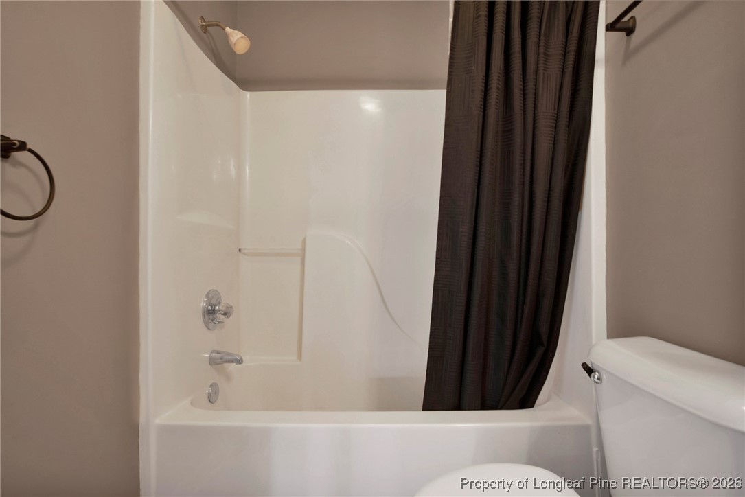 3824 Constance Road Hope Mills, NC 28348 - Photo 21 of 32 a bathroom with a bathtub and shower