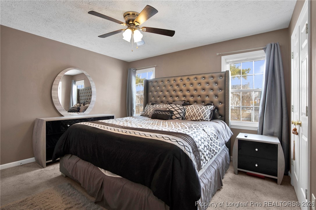 3824 Constance Road Hope Mills, NC 28348 - Photo 23 of 32 a bedroom with a large bed and a large window