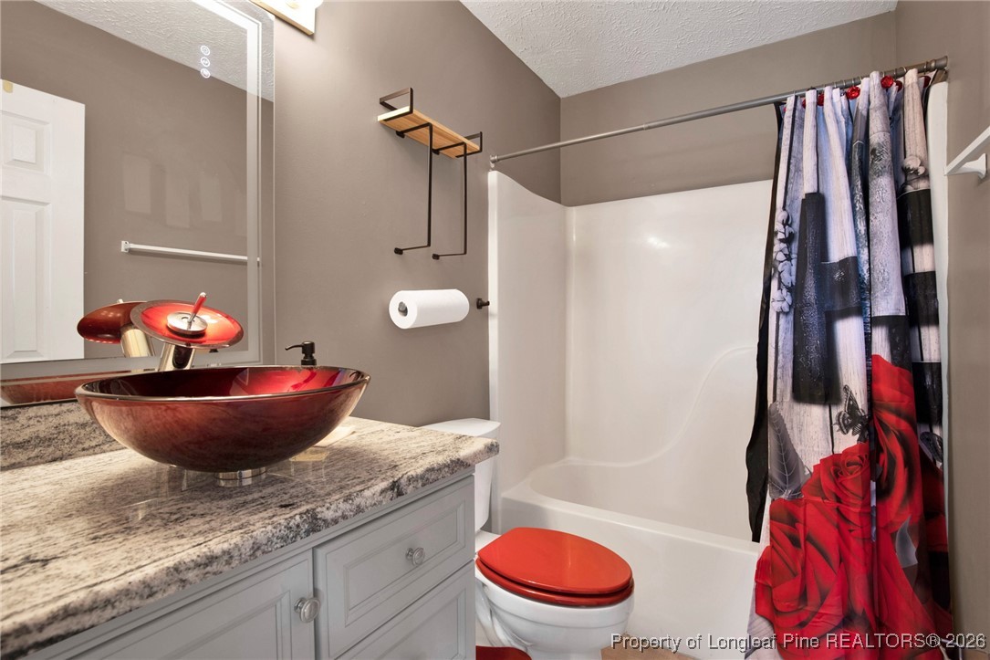 3824 Constance Road Hope Mills, NC 28348 - Photo 24 of 32 a bath room with a toilet and a shower