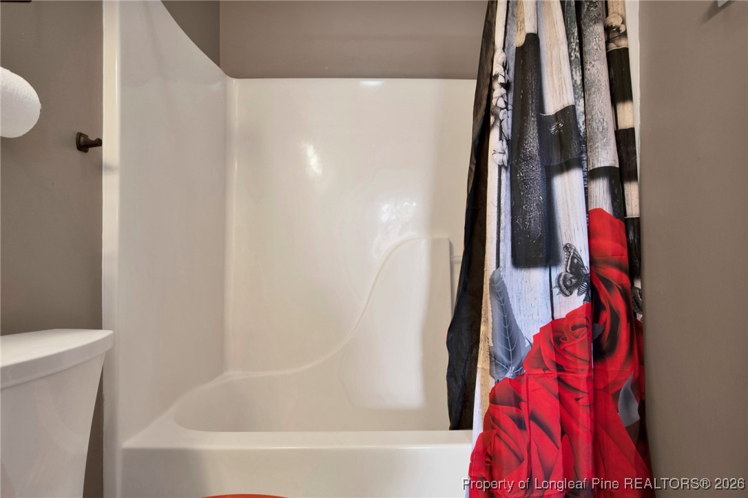 3824 Constance Road Hope Mills, NC 28348 - Photo 25 of 32 a bathroom with a bathtub and a shower