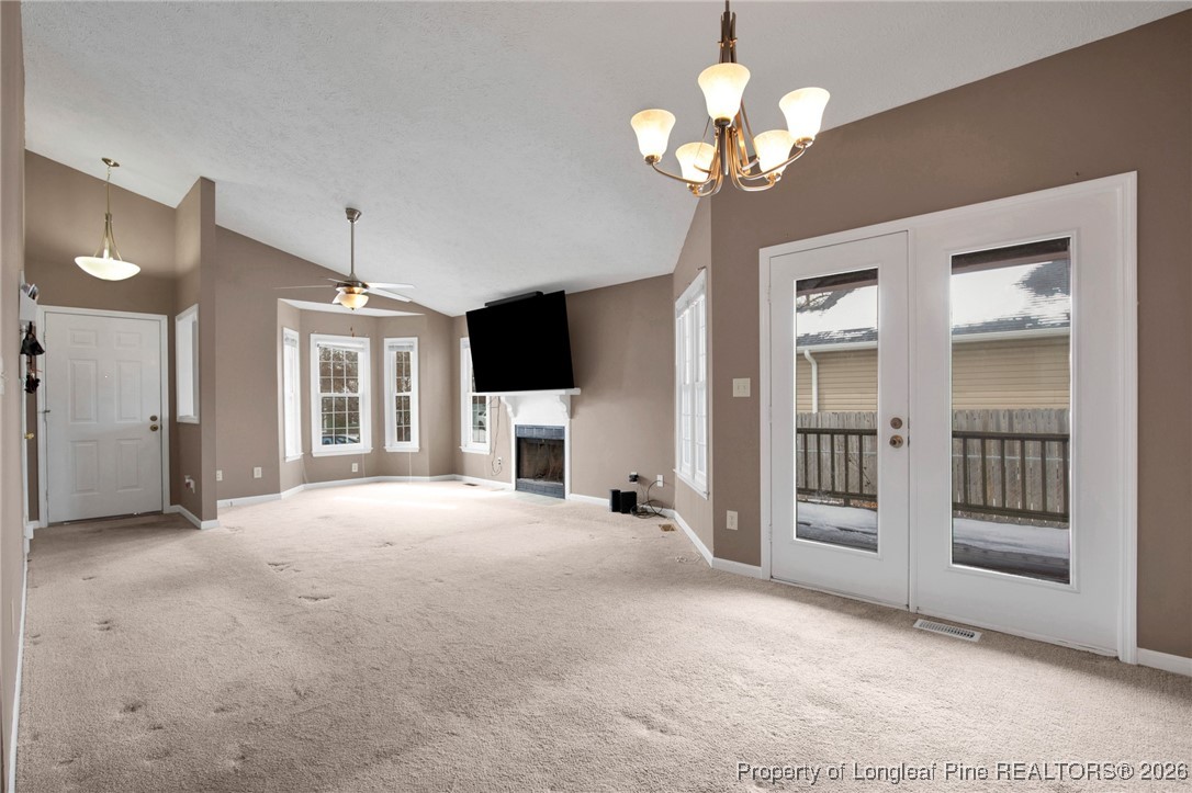 3824 Constance Road Hope Mills, NC 28348 - Photo 6 of 32 a view of an empty room with a fireplace and a chandelier