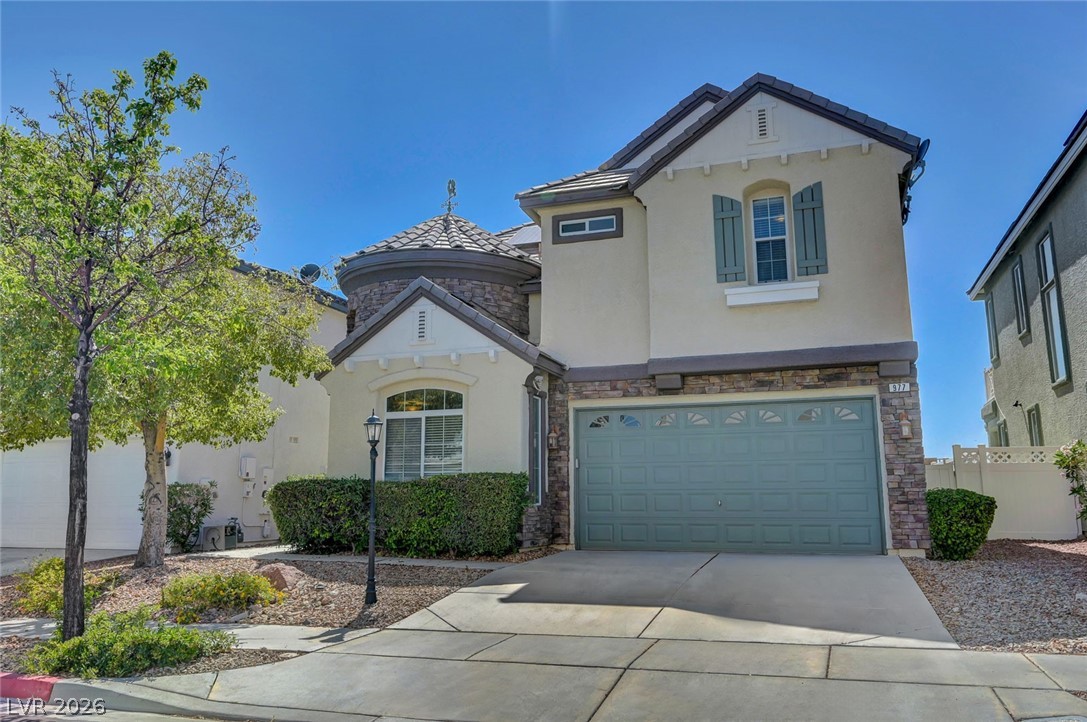 977 Sparkling Light Street Henderson, NV 89052 - Photo 2 of 75 This charming home features a lovely stone facade and a two-car garage, offering both curb appeal and practicality.